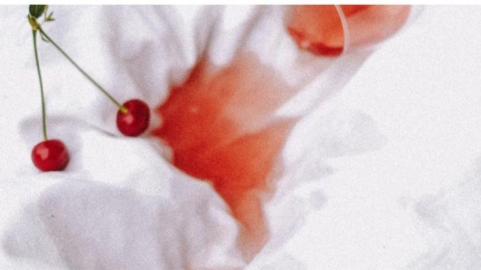 commercial stain removers displayed next to fabric, highlighting the most effective products for removing oil stains